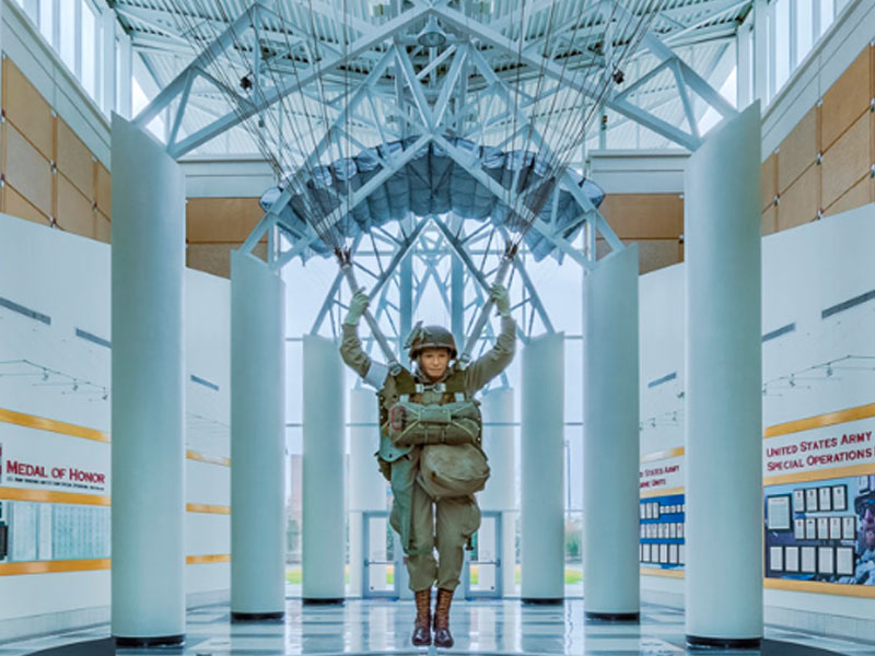 A parachuter exhibit in a large hallway inside the Airborne and Special Operations Museum.